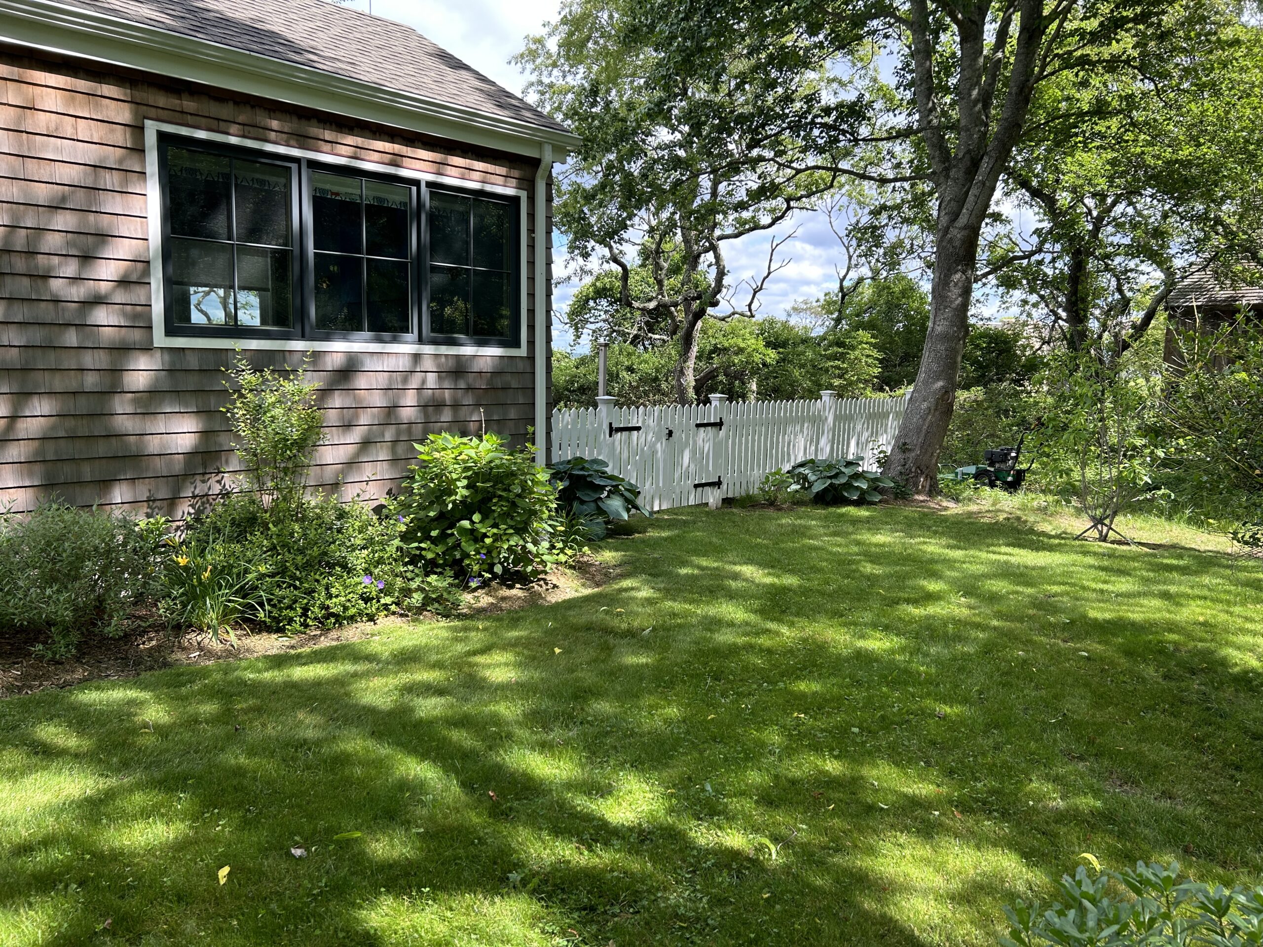 Cedar picket fence with white stain and double gate installed by Arrow Fence Inc in Connecticut